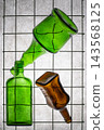 Three empty glass bottles on a gray background 143568125