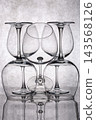 Five glass goblets against a gray background 143568126