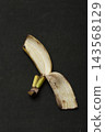 Banana peel on a dark background, top view 143568129