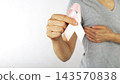 Woman Holding Pink Ribbon for Breast Cancer Awareness with Copy-space 143570838