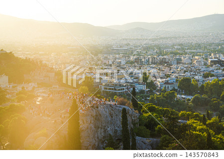 Tourists enjoying sunset cityscape view from Areopagus Hill Tourists enjoying sunset cityscape view from Areopagus Hill 143570843