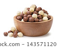 Sweet cereal balls in a wooden bowl on a white background. Isolated 143571120