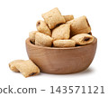 Cereal pads in a wooden bowl close-up on a white background. Isolated 143571121