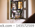 Open electrical board and circuit breaker box installed on a wall. 143572509