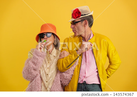 Mature couple enjoying lollipops and having fun 143574367