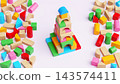 Completed Tower Construction Made of Colorful Wooden Toy Building Blocks on Pastel Surface 143574411