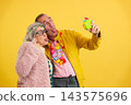 Cheerful mature couple making funny faces capturing a selfie 143575696