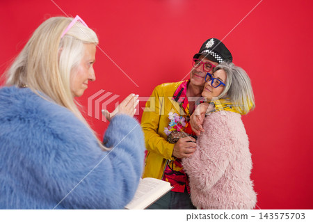 Seniors celebrating wedding and active maturity with colorful clothing Seniors celebrating wedding and active maturity with colorful clothing 143575703