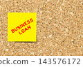 Yellow note paper with word business loan on cork board background with copy space 143576172