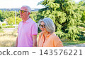 Senior couple enjoying happy walking outdoors together 143576221