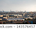 Laem Chabang factory rooftops and container port cranes by sea horizon in Chonburi, Thailand 143576457