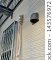 Protecting air conditioning piping during exterior wall painting work. 143576972
