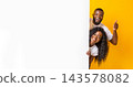 African American woman And Guy Holding White Advertising Board, guy showing thumb up, yellow studio background, panorama 143578082