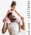 Beautiful portrait of happy african father holding his little daughter on his neck, white background 143578084