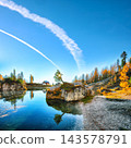 Amazing autumn view of  Lake Federa  at sunrise with majestic rocky mount and colorful trees glowing sunlight in Dolomites 143578791