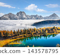 Amazing  aerial view of  crystal clear Lake Federa in Dolomites Alps under sunlight in mist and fog. 143578795