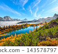 Breathtaking  aerial view of  crystal clear Lake Federa in Dolomites Alps under sunlight in mist and fog 143578797