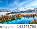 Amazing  aerial view of  crystal clear Lake Federa in Dolomites Alps under sunlight in mist and fog. 143578798