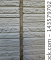 Deteriorated and cracked joints in the siding exterior wall 143579702