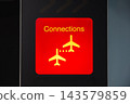 Red connections sign points travelers to their next gate. A bright red connections sign with plane icons points travelers on toward their next gate. Clear wayfinding colour built to cut through a busy 143579859