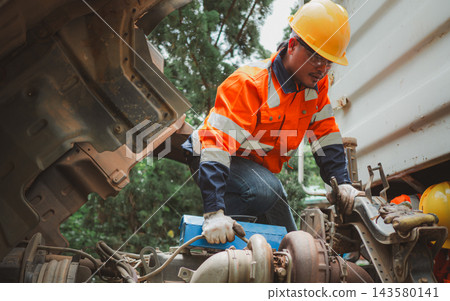 Asian Male Mechanic Inspecting Heavy Truck Engine in Maintenance Repair 143580141