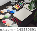 Professional watercolor swatches artist workspace setup. Watercolor swatches artist workspace with blank paper sheet and brushes. Clean watercolor swatches artist workspace displays painting 143580691
