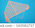 A knitted women's headscarf on a colorful background. 143581737