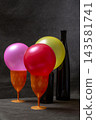 Still life with three balloons, glasses, and glass bottles 143581741