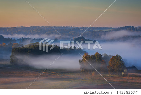 Fields covered in fog in Kernave, Lithuania Fields covered in fog in Kernave, Lithuania 143583574