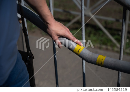 A blind woman reads the inscription on the railing of a staircase. A blind woman reads the inscription on the railing of a staircase. 143584219