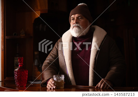 Elegant Santa seated at bar with an amber drink Elegant Santa seated at bar with an amber drink 143587213