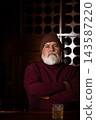 Serious senior man in red sweater at elegant bar 143587220