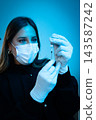 Female doctor drawing medicine into syringe 143587242