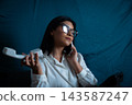 Young woman multitasking with modern and vintage phone 143587247