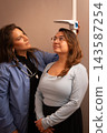 Doctor checking standing patient's height in clinic 143587254