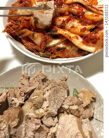 Suyuk, a traditional Korean dish of boiled pork slices, tender and juicy, often served with salted shrimp sauce, garlic, and ssamjang. Perfect for wrapping in lettuce for a flavorful, balanced bite. Suyuk, a traditional Korean dish of boiled pork slices, tender and juicy, often served with salted shrimp sauce, garlic, and ssamjang. Perfect for wrapping in lettuce for a flavorful, balanced bite. 143588312
