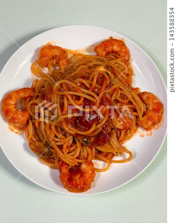 Classic spaghetti coated in rich tomato sauce, offering a simple yet delicious combination of tangy, savory flavors perfect for a comforting meal. Classic spaghetti coated in rich tomato sauce, offering a simple yet delicious combination of tangy, savory flavors perfect for a comforting meal. 143588354