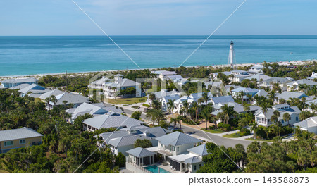 Premium housing development in the USA. Expensive waterfront houses between green palm trees in Boca Grande, small town on Gasparilla Island in southwest Florida Premium housing development in the USA. Expensive waterfront houses between green palm trees in Boca Grande, small town on Gasparilla Island in southwest Florida 143588873