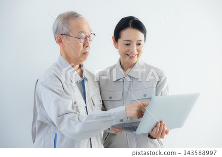 身著工作服的老年男性和中年女性 身著工作服的老年男性和中年女性 143588997