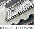 A retro Showa-era old house with a mortar exterior and rusted iron window grilles. 143589240
