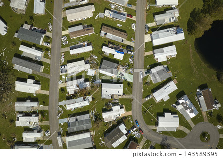 Severely damaged by hurricane Ian houses in Florida mobile home residential area. Consequences of natural disaster Severely damaged by hurricane Ian houses in Florida mobile home residential area. Consequences of natural disaster 143589395