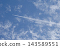 The shadow of a contrail is falling on cirrocumulus clouds. 143589551