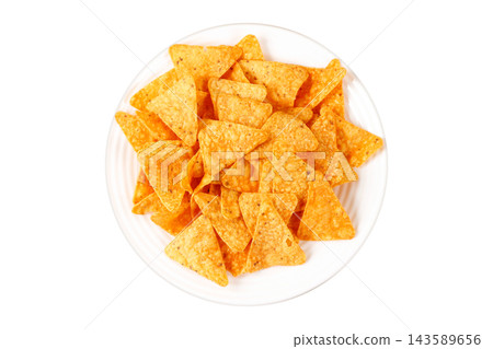 Crispy baked triangular tortilla chips nachos on a white ceramic plate, isolated on a white background. Mexican cuisine. 143589656