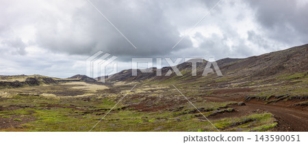 Volcanic Landscape with Moss and Dirt Road in Iceland Volcanic Landscape with Moss and Dirt Road in Iceland 143590051
