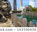 The moat and stone walls of Takamatsu Castle ruins, with the platform of Kotoden Takamatsu Chikko Station visible in the background (Takamatsu City, Kagawa Prefecture). 143590438