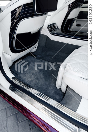 Interior view of a luxury car showing plush seats and modern design details 143591220