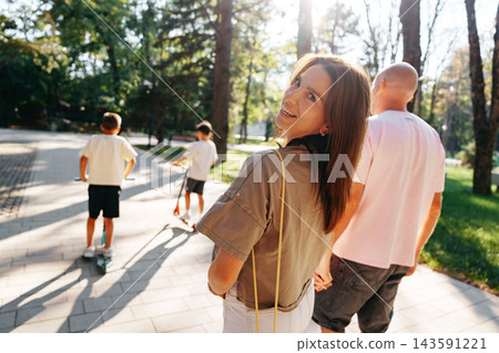 Family stroll in the park during afternoon with kids and adults enjoying time together 143591221