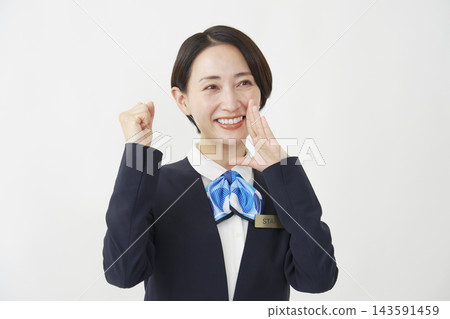 一位中年女員工在白色背景前為其他人加油，面向右側。 143591459
