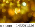 Golden lights on a blurred background. Close-up of Christmas decorations. Ideal for social media backgrounds. 143591886