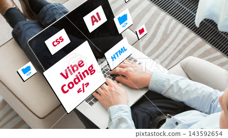 Learning vibe coding concepts with a laptop and software symbols displayed on a screen 143592654